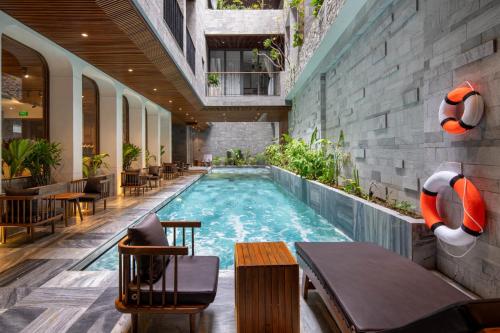 a swimming pool in the middle of a building at VernalHome Boutique Danang in Da Nang