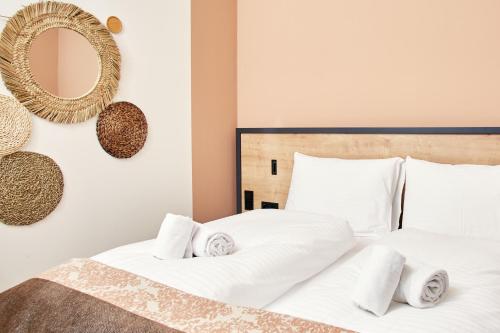 a bedroom with two white beds and a mirror at HOMEBOUND APARTMENTS Bad Goisern - contactless check-in in Bad Goisern