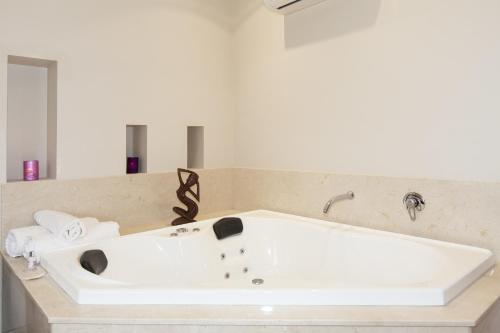 a white bath tub in a bathroom with towels at Grampians Manor House in Halls Gap