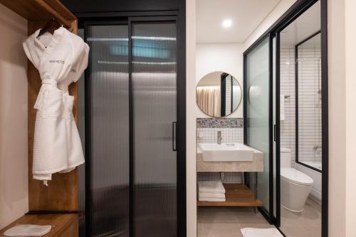 a bathroom with a sink and a mirror at ARA Hotel in Seoul