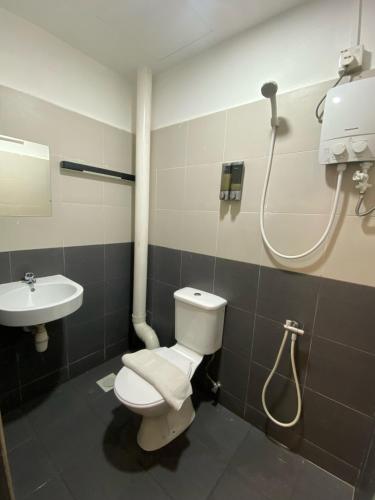 a bathroom with a toilet and a sink at V Hotel Johor Bahru in Johor Bahru