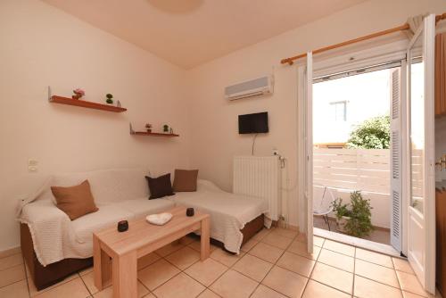 a living room with a couch and a table at CENTRAL APARTMENTs in Ermoupoli