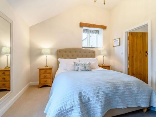 a bedroom with a large bed and two night stands at Middle Mistal in Stainburn