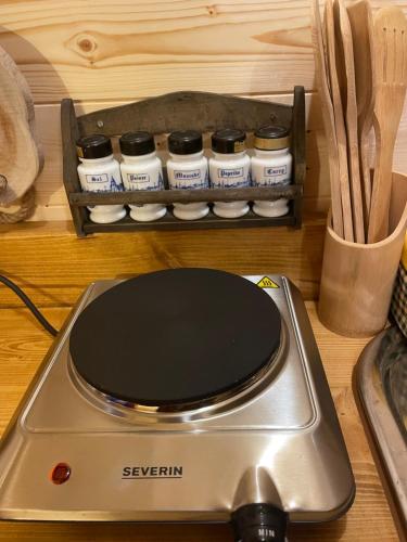 a silver scraper sitting on a counter with spices at La Rouloulotte in Durbuy