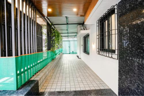 a corridor of a building with green and white walls at FabHotel Viva House - Talegaon in Pune