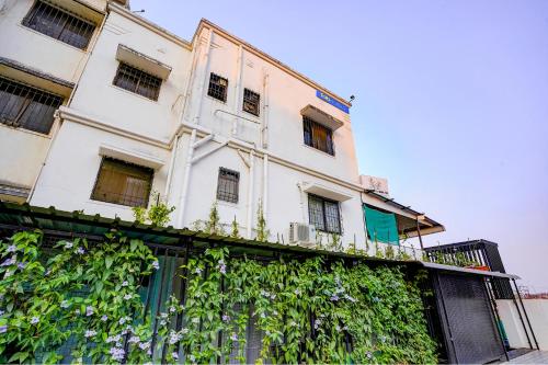 a white building with plants on the side of it at FabHotel Viva House - Talegaon in Pune