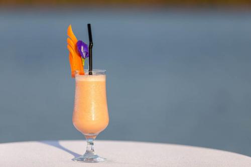 a glass of orange juice with carrots in it at Castle Bayview Resort & Spa in Kampot