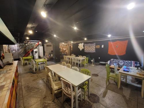 a restaurant with tables and chairs in a room at Doobaki Hostel in Gyeongju