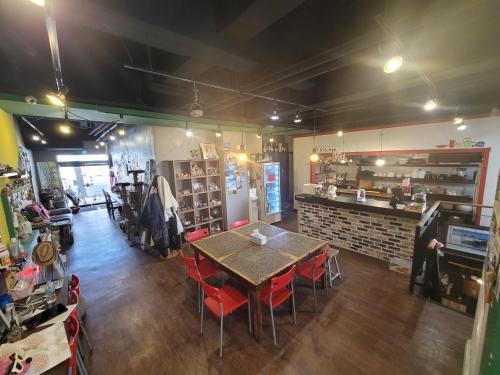 a restaurant with a table and chairs in a room at Doobaki Hostel in Gyeongju