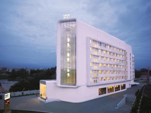 a large white building with a large window at Keys Select by Lemon Tree Hotels, Hosur Road, Bengaluru in Bangalore
