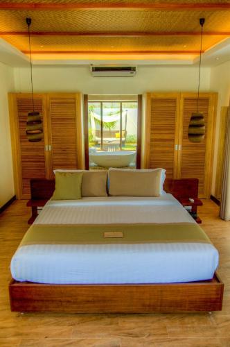 a bedroom with a large bed in a room at Kandaya Resort in Daanbantayan