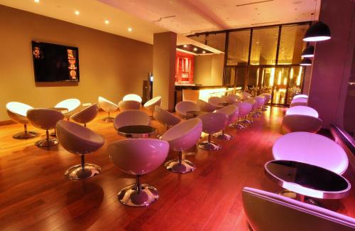 a row of chairs in a salon with wooden floors at Keys Select by Lemon Tree Hotels, Kochi in Cochin
