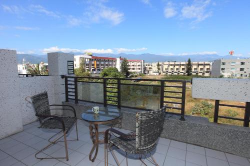 a patio with a table and chairs on a balcony at Dali Moonlight B&B in Taitung City