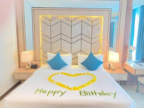 a bedroom with a bed with a happy anniversary sign on it at Castle Bayview Resort & Spa in Kampot