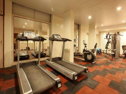 a gym with two treadmills and several exercise bikes at Evershine Resort & Spa in Mahabaleshwar