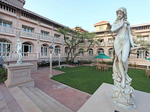 a statue of a woman in front of a building at Evershine Resort & Spa in Mahabaleshwar