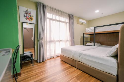 a bedroom with a bed and a large window at 3C HOTEL Setia Walk Puchong in Puchong