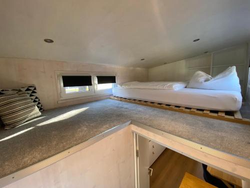 a bedroom with a bed in the middle of it at Tiny House Stever im PIER9 Tiny House Hotel in Hamm