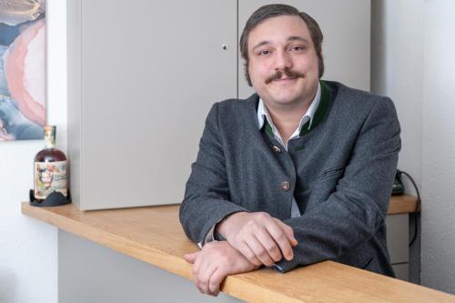 a man sitting at a desk with his arms crossed at Gasthaus Hinterbrühl in Salzburg