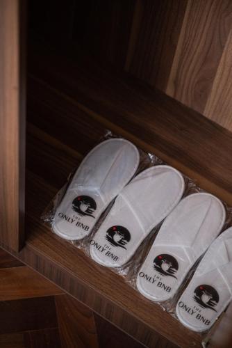 a group of white surfboards in a wooden shelf at Large Family Seaview Suite 3 Rooms by The Only Bnb in Tanjong Tokong