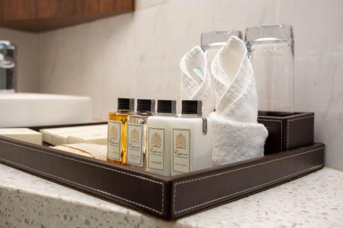 a tray with products on a counter in a bathroom at Castle Bayview Resort & Spa in Kampot