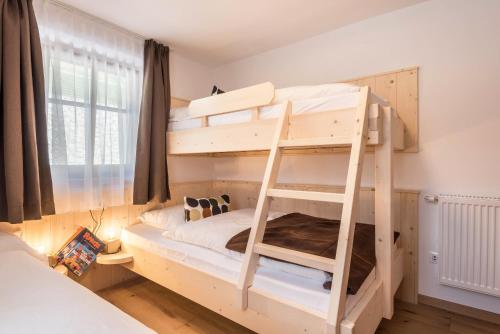 a room with two bunk beds with a ladder at Sparberhof Exklusive in Campo di Trens
