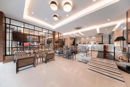 a lobby of a restaurant with tables and chairs at At 115 Hotel By Rompo in Bangkok