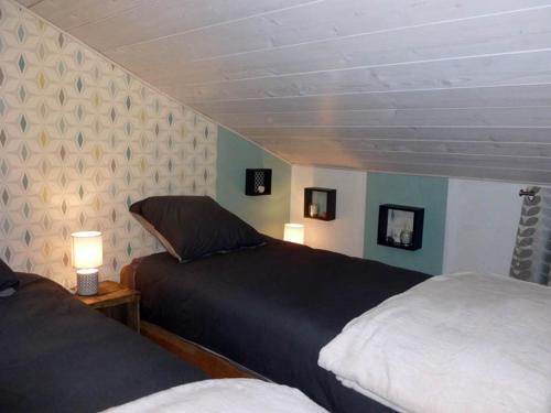 a bedroom with two beds and two lamps in it at la Bergerie du Bois Joannin 1497 route des fleuriats in Iguerande