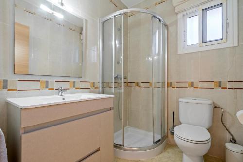 a bathroom with a shower and a toilet and a sink at Llastres in Miami Platja