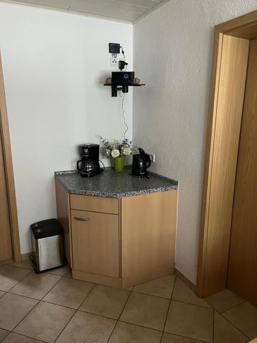a kitchen with a counter with two coffee makers on it at Bergblick 2 in Masserberg