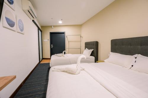 Postel nebo postele na pokoji v ubytování 3C HOTEL Setia Walk Puchong