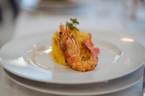 a shrimp on a white plate on a table at Grand Hotel Terme in Riolo Terme