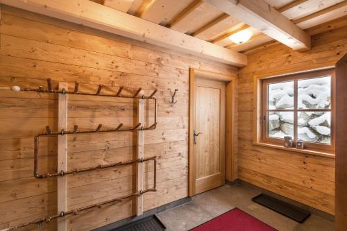 a room with wooden walls and a window at Prenner Alm in Haus im Ennstal