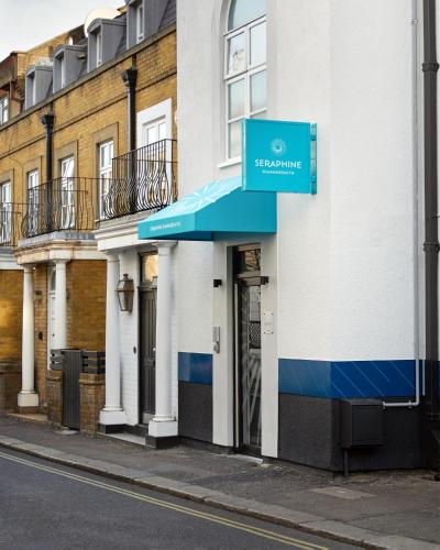 a building with a blue awning on a street at Seraphine Hammersmith Hotel in London