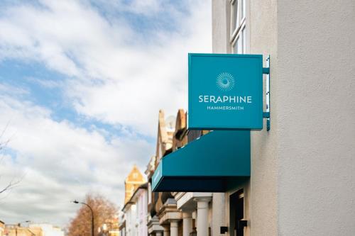 a blue sign on the side of a building at Seraphine Hammersmith Hotel in London