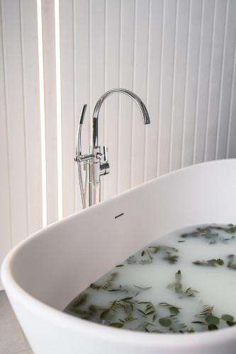 a sink with a faucet in a bathroom at Sniegi design cabin with sauna in Madona