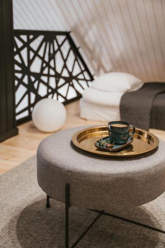 a coffee table with a coffee cup on it in a room at Sniegi design cabin with sauna in Madona