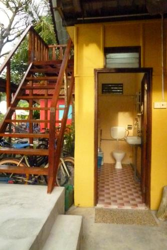 a bathroom with a toilet in a building at Cheers Garden Chalet in Kampung Tekek