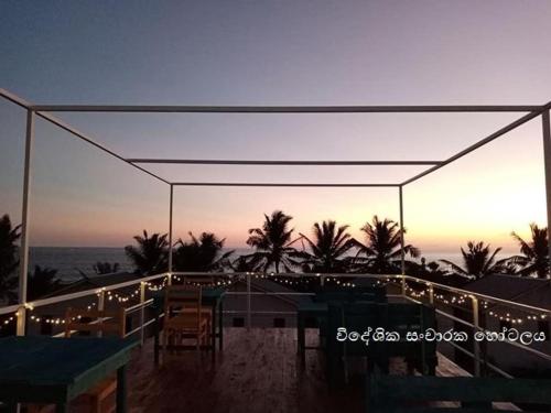 a view of a beach with a tent and the ocean at South Sea Villa in Midigama