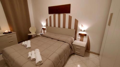 a bedroom with a bed with white shoes on it at La Casa di Elisa in Cagliari