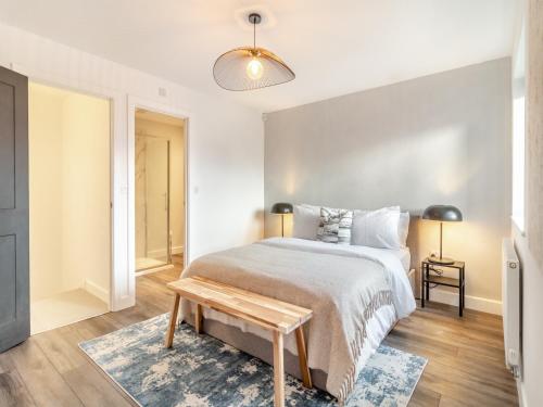 a bedroom with a large bed and a wooden floor at Vancouver View in King's Lynn