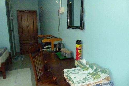 a dining room table with a cake on top of it at Cheers Garden Chalet in Kampung Tekek