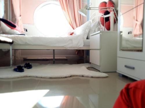a hospital room with two beds and a white rug at Apartman Bella Vita in Kolašin