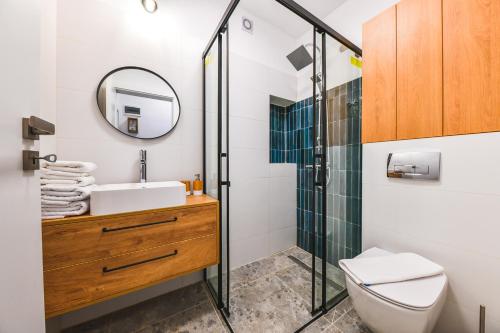 a bathroom with a sink and a shower at Designer Central Getaway in Cluj-Napoca