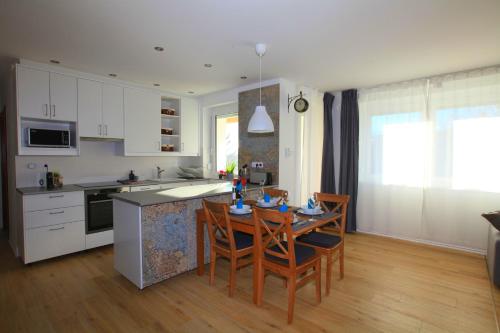a kitchen and dining room with a table and chairs at Paskal-Lux Apartments with free parking in Budapest