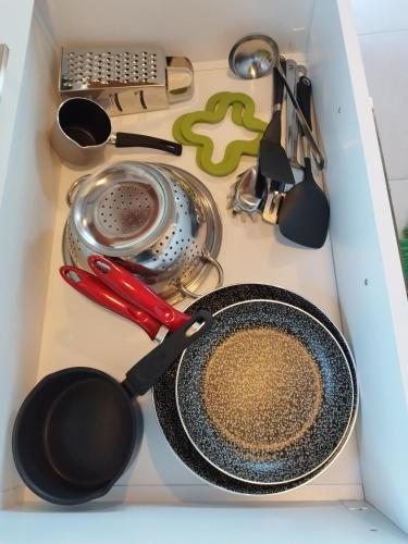 a kitchen sink with a frying pan and utensils at Mary's Panorama Houses in Gialova