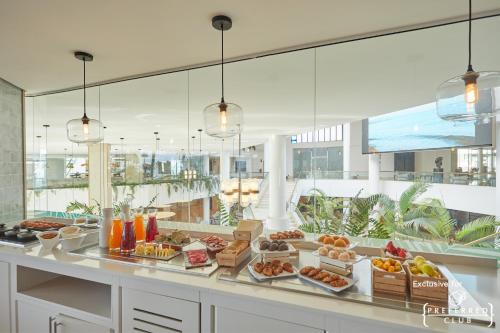 a buffet with many different types of food on a counter at Dreams Lanzarote Playa Dorada Resort & Spa in Playa Blanca