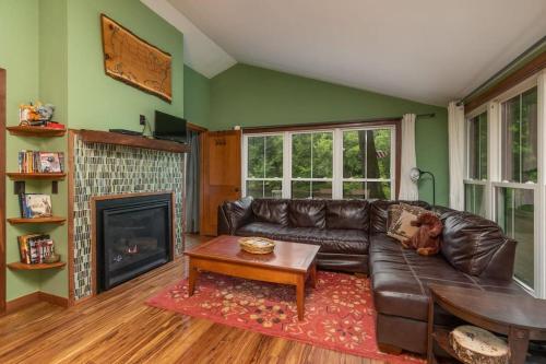 a living room with a leather couch and a fireplace at $99 midweek-2 bedroom-Riverfront-Fireplace- Pet ok in Pine City
