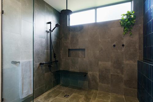 a bathroom with a shower with a glass door at Castlemaine Gardens Luxury Accessible Villa in Castlemaine