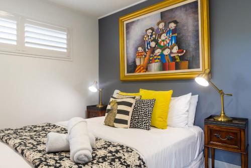 a bedroom with two beds and a painting on the wall at Contemporary Studio in the heart of Paddington in Brisbane